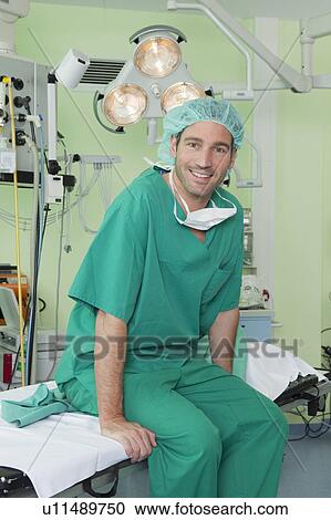 Doctor with scrubs on couch, happy View Large Photo Image Stock Image - Doctor with scrubs on couch, happy. Fotosearch