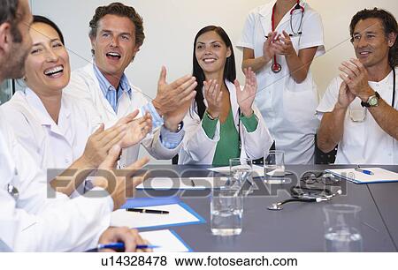 Stock Photo - Doctors applauding their chief. Fotosearch
