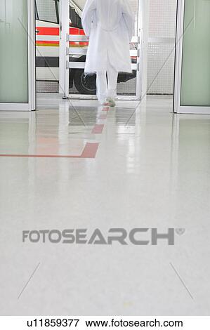 Stock Photo - Doctors back rushing through hall. Fotosearch