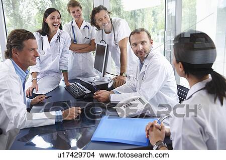 Doctors laughing with their colleagues View Large Photo Image Picture - Doctors laughing with their colleagues. Fotosearch
