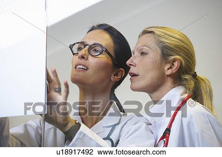 Stock Image - Doctors looking at a file. Fotosearch