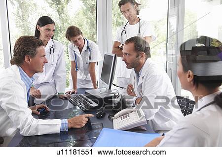 Doctors meeting to discuss files View Large Photo Image Stock Image - Doctors meeting to discuss files. Fotosearch