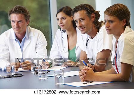 Doctors meeting to discuss files View Large Photo Image Stock Image - Doctors meeting to discuss files. Fotosearch