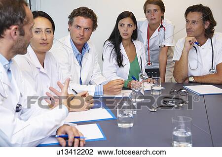 Doctors meeting to discuss files View Large Photo Image Stock Image - Doctors meeting to discuss files. Fotosearch