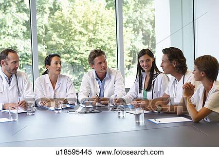 Stock Photography - Doctors meeting to discuss files. Fotosearch