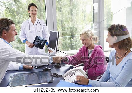 Doctors with patients, in office View Large Photo Image Stock Photography - Doctors with patients, in office. Fotosearch