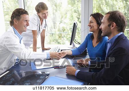 Doctors with patients, in office View Large Photo Image Stock Photography - Doctors with patients, in office. Fotosearch