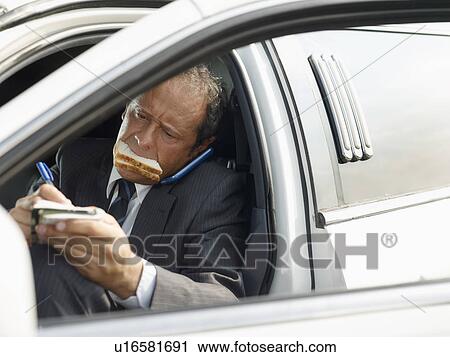 Driver eating sandwich on limousine View Large Photo Image Stock Image - Driver eating sandwich on limousine. Fotosearch