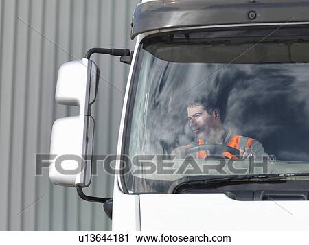 Driver looking in truck mirror View Large Photo Image Stock Image - Driver looking in truck mirror. Fotosearch