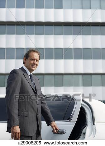 Driver opening door of limousine View Large Photo Image Stock Photography - Driver opening door of limousine. Fotosearch