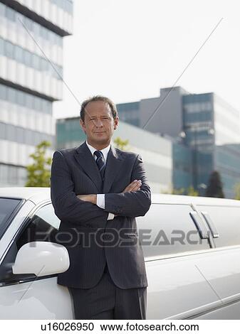 Driver standing near limousine View Large Photo Image Stock Image - Driver standing near limousine. Fotosearch