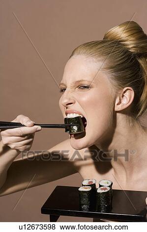 Stock Photo - Eating sushi. Fotosearch