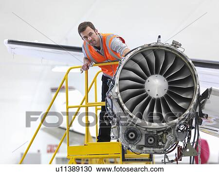 Engineer inspecting jet engine View Large Photo Image Stock Image - Engineer inspecting jet engine. Fotosearch
