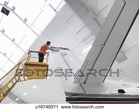 Engineer inspects jet aircraft View Large Photo Image Stock Image - Engineer inspects jet aircraft. Fotosearch