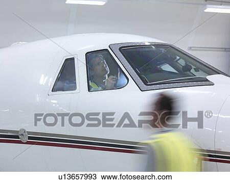 Engineer inspects jet cockpit View Large Photo Image Stock Image - Engineer inspects jet cockpit. Fotosearch