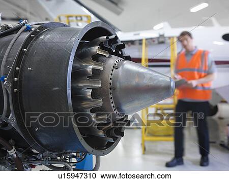 Engineer inspects jet engine View Large Photo Image Stock Image - Engineer inspects jet engine. Fotosearch
