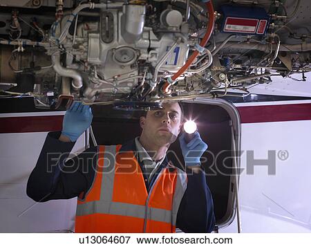 Engineer inspects jet engine View Large Photo Image Stock Photo - Engineer inspects jet engine. Fotosearch