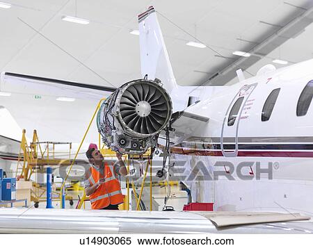 Engineer inspects jet engine View Large Photo Image Stock Photography - Engineer inspects jet engine. Fotosearch