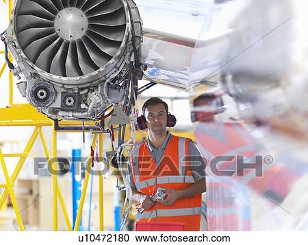 Engineer with jet engine View Large Photo Image Stock Image - Engineer with jet engine. Fotosearch