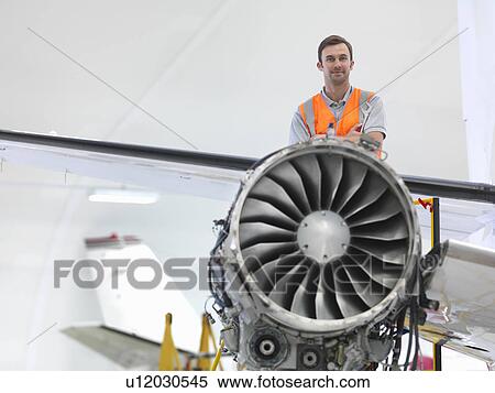 Stock Photography - Engineer with jet engine. Fotosearch