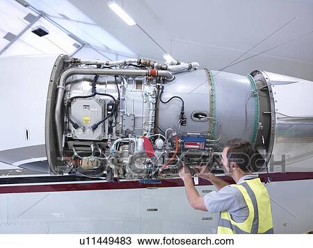 Engineer working on jet engine View Large Photo Image Stock Image - Engineer working on jet engine. Fotosearch