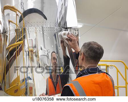 Engineer works on jet aircraft View Large Photo Image Stock Photo - Engineer works on jet aircraft. Fotosearch