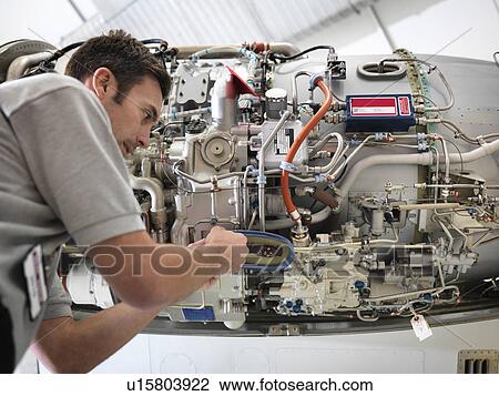 Engineer works on jet engine View Large Photo Image Stock Image - Engineer works on jet engine. Fotosearch