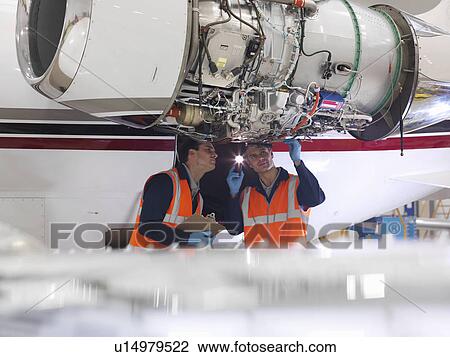 Engineers inspect a jet engine View Large Photo Image Stock Image - Engineers inspect a jet engine. Fotosearch