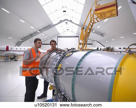 Stock Image - Engineers inspect jet engine. Fotosearch