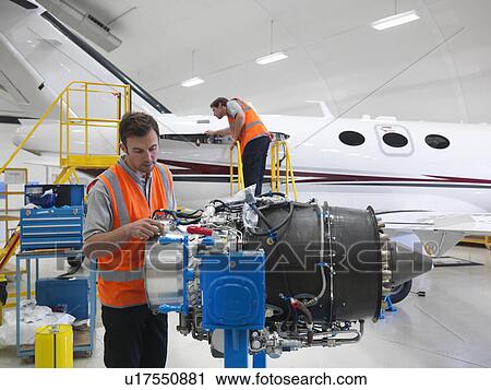 Engineers inspect jet engine View Large Photo Image Stock Image - Engineers inspect jet engine. Fotosearch
