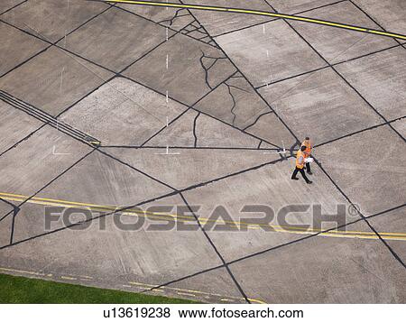 Stock Photo - Engineers on aircraft runway. Fotosearch