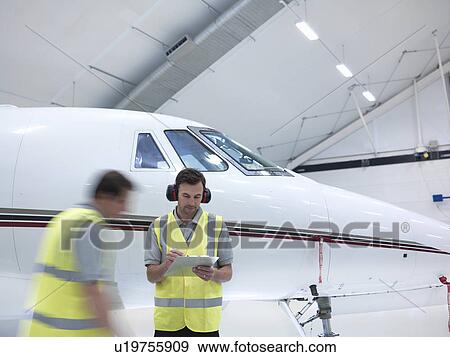 Stock Photo - Engineers with a jet aircraft. Fotosearch