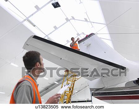 Stock Photography - Engineers with jet aircraft. Fotosearch