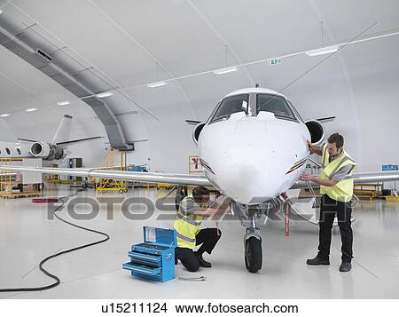 Engineers working on jet aircraft View Large Photo Image Picture - Engineers working on jet aircraft. Fotosearch