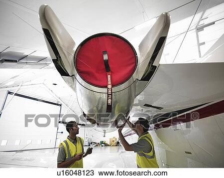 Engineers working on jet aircraft View Large Photo Image Stock Image - Engineers working on jet aircraft. Fotosearch