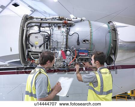 Stock Photo - Engineers working on jet engine. Fotosearch