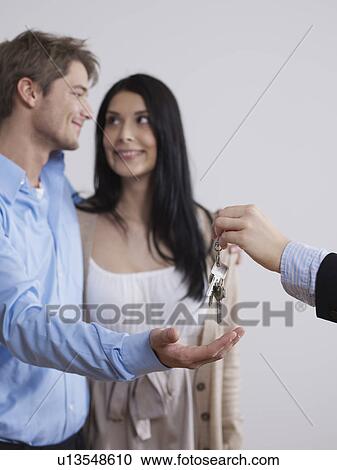 Estate agent hands over keys View Large Photo Image Stock Image - Estate agent hands over keys. Fotosearch