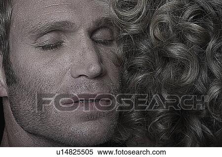 Stock Photography - Face of a man hugging a woman. Fotosearch