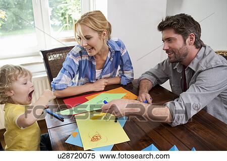 Stock Photography - Family handcrafting on table. Fotosearch