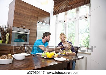 Stock Photo - Family having breakfast. Fotosearch
