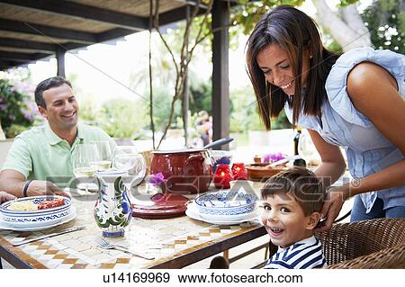 Family having lunch together View Large Photo Image Stock Photo - Family having lunch together. Fotosearch