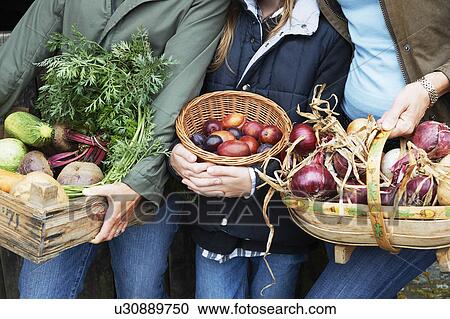 Family holding vegetables View Large Photo Image Stock Image - Family holding vegetables. Fotosearch