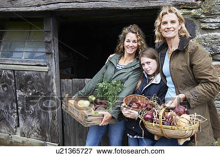 Family holding vegetables View Large Photo Image Stock Photo - Family holding vegetables. Fotosearch