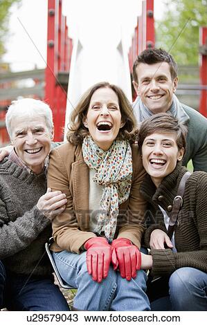 Family in the park laughing View Large Photo Image Stock Image - Family in the park laughing. Fotosearch