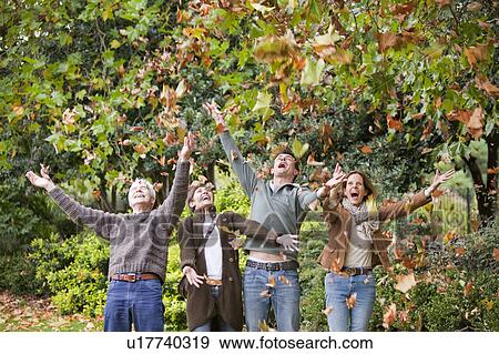 Family in the park throwing leaves View Large Photo Image Stock Photo - Family in the park throwing leaves. Fotosearch