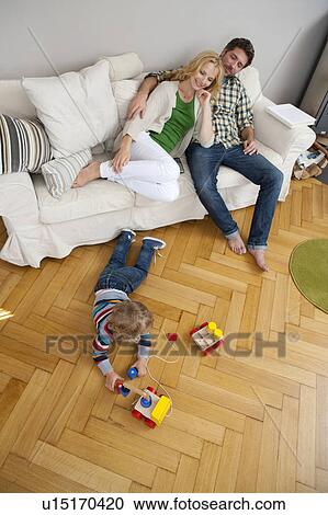 Stock Image - Family in their living room. Fotosearch