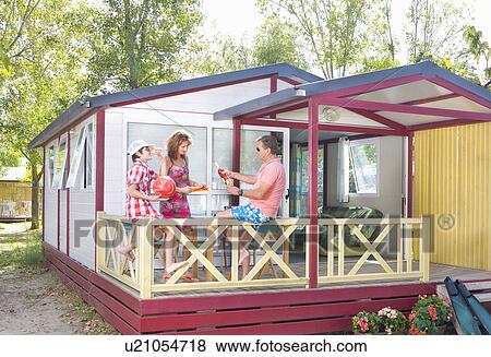 Stock Photo - Family on vacation on terrace with wine. Fotosearch