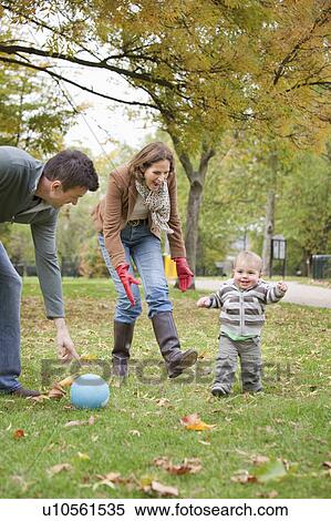 Stock Photography - Family play soccer in the park. Fotosearch