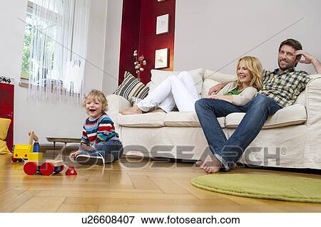 Family playing in living room View Large Photo Image Stock Photo - Family playing in living room. Fotosearch