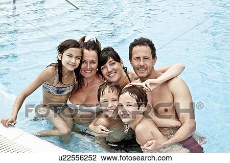Stock Image - Family portrait in pool. Fotosearch